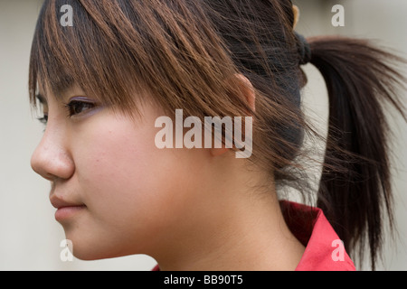 BEIJING CHINA MAY 2006  Bar Jing, 20, stands on the street a week after plastic surgery to raise the bridge of her nose. Stock Photo