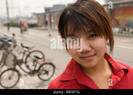 BEIJING CHINA MAY 2006  Bar Jing, 20, stands on the street a week after plastic surgery to raise the bridge of her nose. Stock Photo