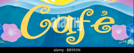 Cafe sign in yellow blues and pinks Stock Photo