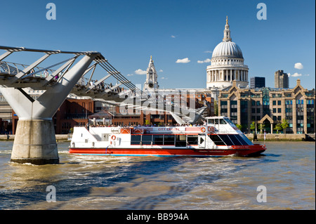 River Thames Tour Boat Passing Beneath the Millennium Bridge with St Pauls Cathedral in Background, London, England, Stock Photo