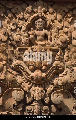 Detail from Banteay Srei, the citadel of the women or beauty, famed for intricate red sandstone carvings of mythical creatures like Kala. Stock Photo