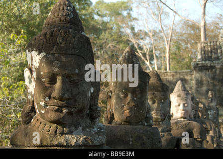 Stone demon faces on the naga bridge at the south gate of Angkor Thom Angkor Seam Reap Cambodia Stock Photo