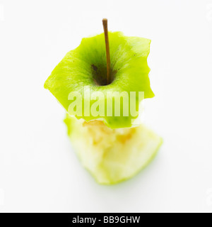 An apple core isolated on a white background, shot with shallow focus to emphasise the strong graphic shape. Stock Photo