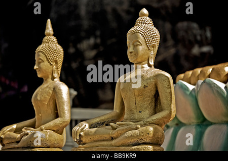 Pair of sitting golden Buddha statues at Khao Takiab Hua Hin Thailand S.E. Asia Stock Photo