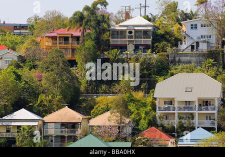 Colourful queenslander houses with metal ('tin') roofs on a steep hillside in Paddington, Brisbane, Australia Stock Photo
