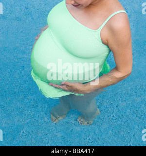 Pregnant woman  in swimming pool Stock Photo