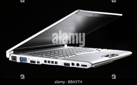 Toshiba laptop against black backdrop, side view, slightly opened Stock Photo