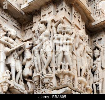 Intricate stone carvings of dancing women and musicians on a temple wall. Jagdish Mandir temple. Udaipur, Stock Photo