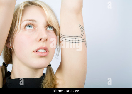 A young woman stretching her arms Stock Photo