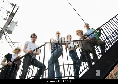 A group of friends standing on a stairway Stock Photo