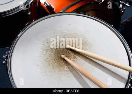 Detail of drumsticks on a drum kit