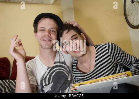 Portrait of a young couple sitting together on a sofa Stock Photo