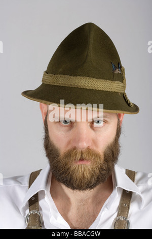 A man wearing an alpine hat and lederhosen Stock Photo
