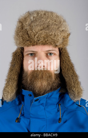A man wearing warm clothing with long mustache hair covering his mouth Stock Photo
