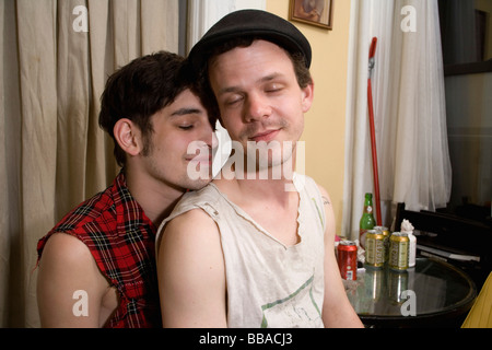 A young couple sitting together with their eyes closed Stock Photo