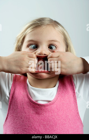 A little girl making a scary face Stock Photo