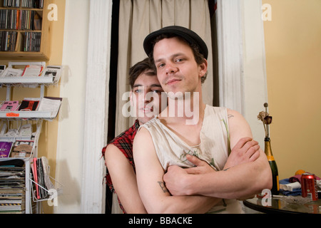 A young couple sitting together in their living room Stock Photo