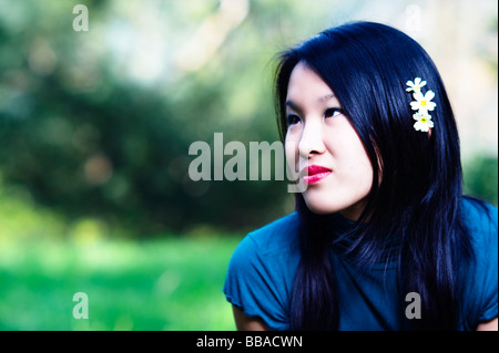 Young Asian girl in a park Stock Photo