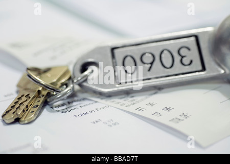 A hotel key and a receipt Stock Photo