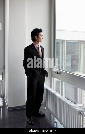 A businessman looking through a window Stock Photo