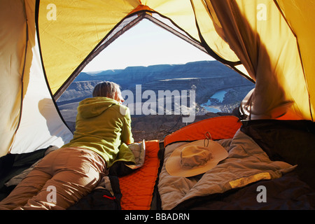 A woman lying in a tent, Horse Shoe Bend, Fish River Canyon, Namibia Stock Photo