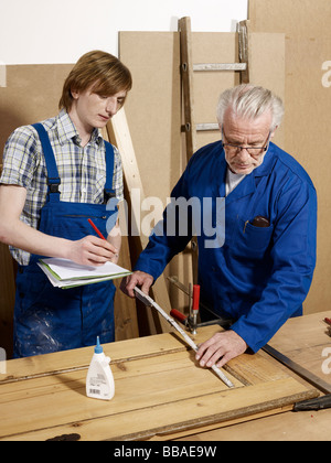 Two men working in a wood workshop Stock Photo