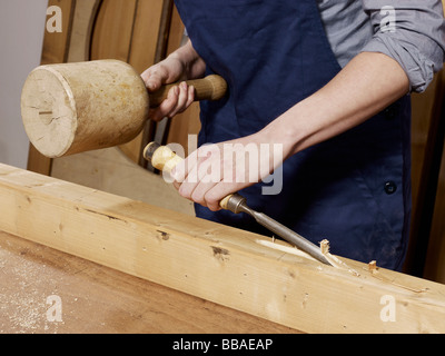Detail of a woman chiseling wood Stock Photo