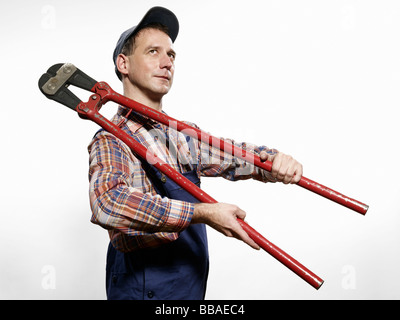 A man holding bolt cutters over his shoulder Stock Photo