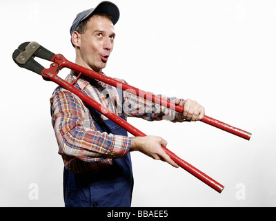 A man holding bolt cutters Stock Photo