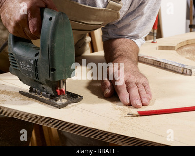 Detail of a man using a jigsaw Stock Photo