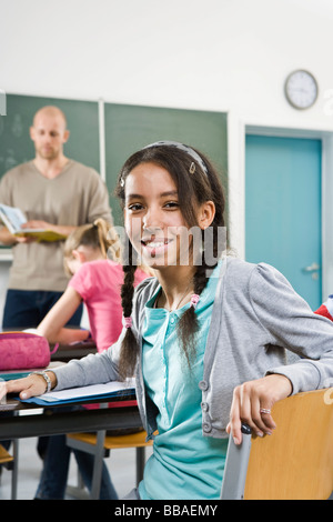 Portrait of a girl sitting in a classroom Stock Photo