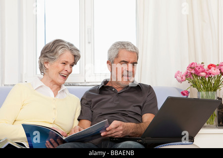 A senior woman and senior man using a laptop Stock Photo