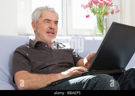A senior man using a laptop Stock Photo