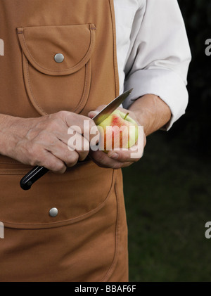 Detail of a man cutting an apple Stock Photo