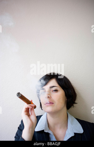 businesswoman smoking cigar Stock Photo