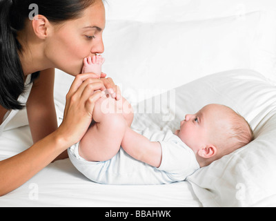 Mother kissing her new-born baby's feet Stock Photo