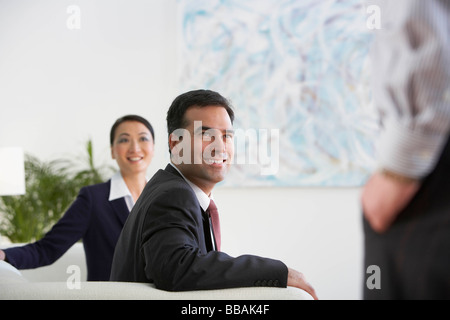 Business colleagues in a lobby area Stock Photo