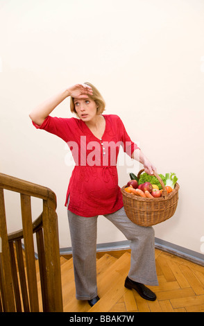 Exhausted pregnant woman in front of her laptop at office Stock Photo ...