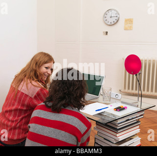 Couple using laptop, woman smiling Stock Photo