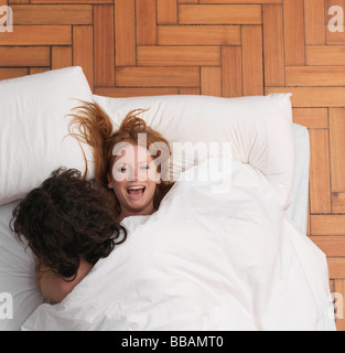 Couple fooling around in bed Stock Photo