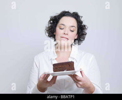 woman looking at plate of cake Stock Photo