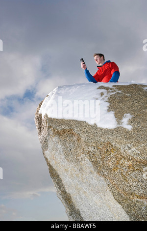 climber taking picture on mountain peak Stock Photo