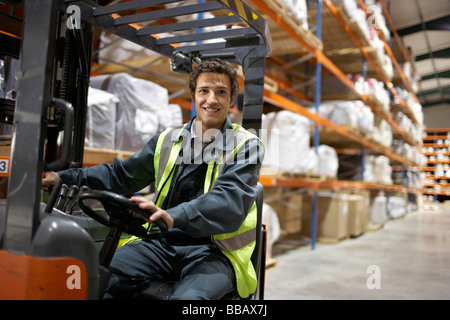 Worker on forklift, smiling to camera Stock Photo