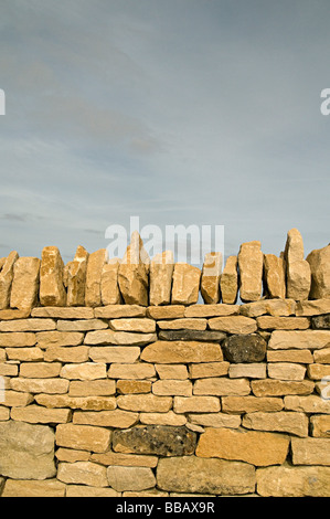 a dry stone wall in the cots wolds a traditional way of building walls in this area Stock Photo