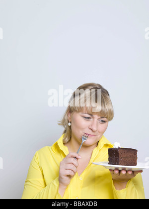 woman looking at plate of cake Stock Photo