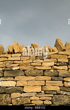 a dry stone wall in the cots wolds a traditional way of building walls in this area Stock Photo
