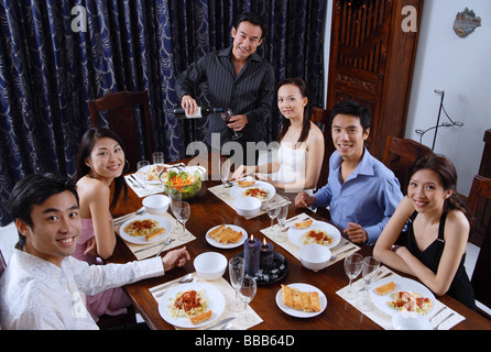 Adults at a dinner party, sitting around table Stock Photo: 24217877 ...