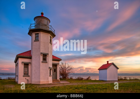 Vashon Island WA Point Robinson lighthouse on Puget Sound with sunset colored sky Stock Photo