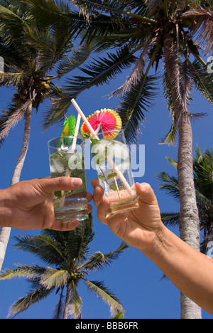 tow adults holding mojito cocktails on the beach (collage) Stock Photo