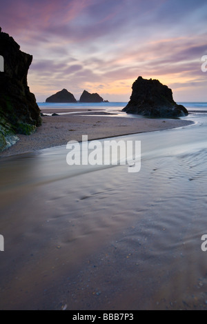 Distant Gull rocks and Holywell Bay beach at sunset Cornwall England UK Stock Photo